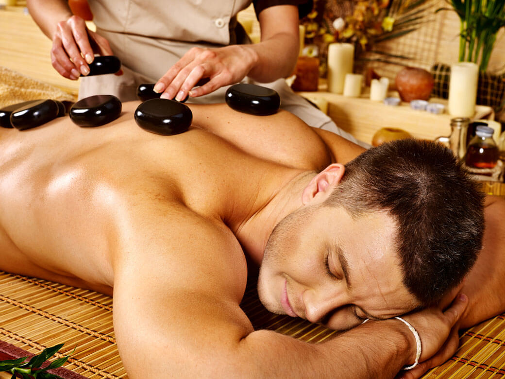 Man Getting Hot Stone Massage at Spa